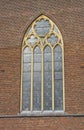A stained-glass arched window on a church. Royalty Free Stock Photo