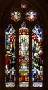 Stained glass cathedral church windows depicting religious scenes