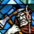 Stained glass image of an orc holding a large axe