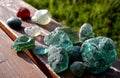 Stained glass from old glassworks smoothed and rounded in a mountain river collected by children beautifully stand out in the sun