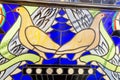 The stained glass window is bright and beautiful in the form of two pigeons of yellow blue color. World tourism