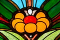 The stained glass window is bright and beautiful in the form of a yellow green blue flower. World tourism flowers