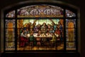 stained glass window depicting the last supper, with a view of individual pieces of mosaic art adorning the background Royalty Free Stock Photo