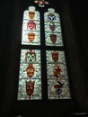 Stained glass window, details of family crests