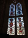 Stained glass window, with family crests, at a slight angle