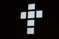 Stained glass window in the form of an Orthodox cross, white light on a black background. Royalty Free Stock Photo