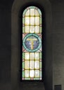 Stained glass window in the Holy Savior Church in Castellina in Chianti, Italy.with