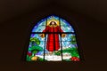 Stained glass window with image of Jesus Christ Ascension among tropical plants. Royalty Free Stock Photo