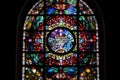 stained glass window of intricate and colorful design, with mosaic border