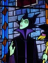 Stained glass window of Maleficent the witch from Disney`s Sleeping Beauty movie. Stained glass window of the Disneyland Paris cas