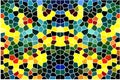 Stained glass window made of polygons of various shapes and colors with white dividing lines