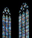 Stained glass windows against a silhouette church wall