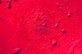 Stained red  painted wall surface . rough plaster texture. sloppy bumpy staining, Grunge textured background with copy space Royalty Free Stock Photo