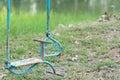 Stained and rusty horse swing on a playground park