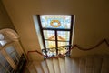 Stained window at the marble staircase in the castle corridor