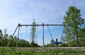 Stainless children`s swings  in an empty public park. Royalty Free Stock Photo