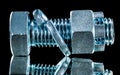 Stainless construction nut screwbolt spring washer on black surf Royalty Free Stock Photo