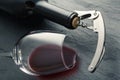 Stainless corkscrew in a cork of bottle neck and wine glass with wine lying on a black slate background Royalty Free Stock Photo