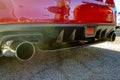 Stainless exhaust pipe at the bottom of red car Royalty Free Stock Photo