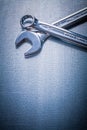 Stainless flat spanner and hook wrench on metallic Royalty Free Stock Photo