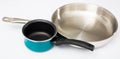 Stainless frying pan and blue non-stick saucepan on white Royalty Free Stock Photo