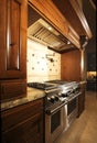 Stainless kitchen oven range and hood Royalty Free Stock Photo