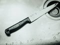 stainless knife after clean and drop of water in sink with murder , horror concept background Royalty Free Stock Photo