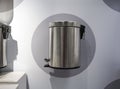 Stainless modern trash can on grey and white wall for display Royalty Free Stock Photo