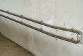 Stainless railing on white wall Royalty Free Stock Photo