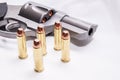 A stainless, snub nosed  357 magnum revolver with five full metal jacket bullets next to it Royalty Free Stock Photo