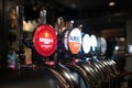 Stainless steel beer taps, craft beer in an English pub, various brands