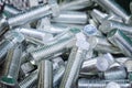 Stainless steel bolts, close-up. A pile of silver bolts. Fasteners made of steel. Construction fixture Royalty Free Stock Photo