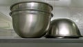 Stainless Steel Bowls At Kitchen Close Up.