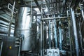 Stainless steel brewing equipment : large reservoirs or tanks and pipes in modern beer factory. Brewery production