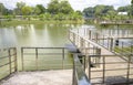 Stainless steel bridge over the pond Royalty Free Stock Photo