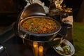 A stainless steel chafing dish filled with mixed vegetable curry at a catered event. Royalty Free Stock Photo