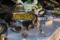 A stainless steel chafing dish with food on a catered buffet table Royalty Free Stock Photo