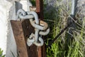 Stainless steel chains winding a rusty metal Royalty Free Stock Photo