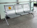 Stainless steel chairs in the train station with disabled signage to facilitate the use of train services for the disabled