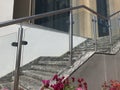 Stainless steel chrome plated finished hand rails with glass panels for an ramp or staircase steps for an building interiors for Royalty Free Stock Photo