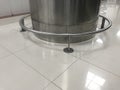 Stainless steel circular column guard images around the Column cladding and fixed with polished marble shaded tile flooring for an