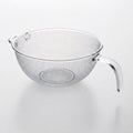 A stainless steel colander isolated against a white background with vignette Royalty Free Stock Photo
