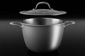 Stainless steel cooker with lid and chrome cookware on black background Royalty Free Stock Photo