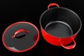 Stainless steel cooker with lid and chrome cookware on black background Royalty Free Stock Photo