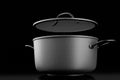 Stainless steel cooker with lid and chrome cookware on black background Royalty Free Stock Photo