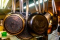 Stainless steel cookware , kitchenware set hanging on a rack on the wall, frying pans and saucepan in modern home retro Royalty Free Stock Photo