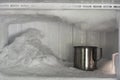 Stainless steel drinking water glass in freezer of a refrigerator. Ice buildup inside of a freezer walls Royalty Free Stock Photo