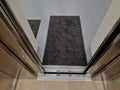 stainless steel elevator cabin interior with hardwood oak floor and mirror