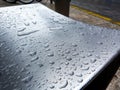 Stainless steel exterior chair and seat after rain with distinct rain drops Royalty Free Stock Photo