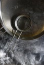 Stainless Steel Fine Mesh Strainer Colander Flour Sieve with Handle on dark background powdered with flour. Kitchenware Royalty Free Stock Photo